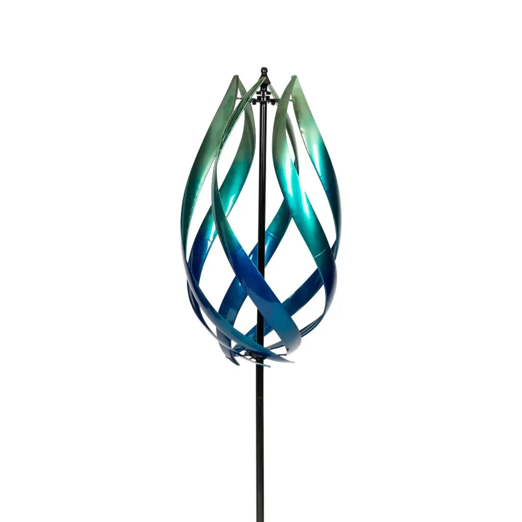 Tall Lotus Wind Spinner in blue, made of powder coated metal, gracefully rotating in a garden setting, adding charm and visual interest.