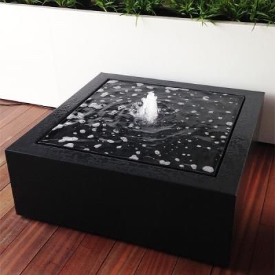 Urban Square Fountain featuring a contemporary black design with bubbling water, ideal for enhancing outdoor spaces.
