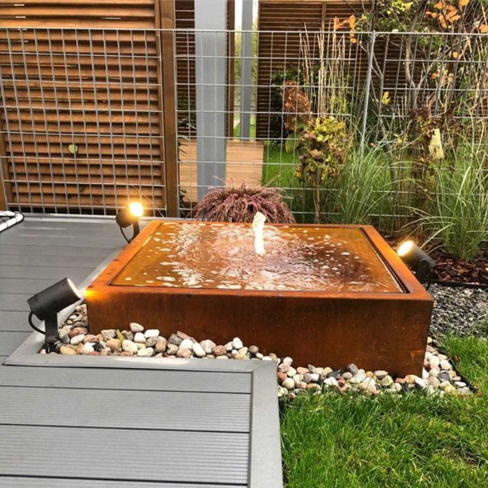Urban Square Fountain highlighted by soft lighting and water ripples, surrounded by stone decoration in a stylish outdoor area.